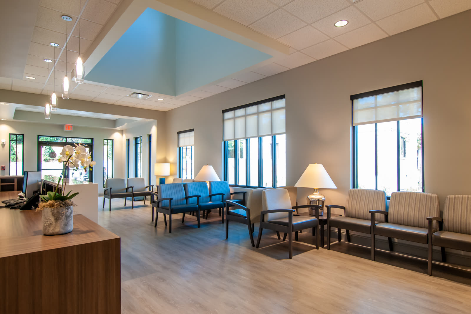 Waiting room with rows of chairs beside the reception desk